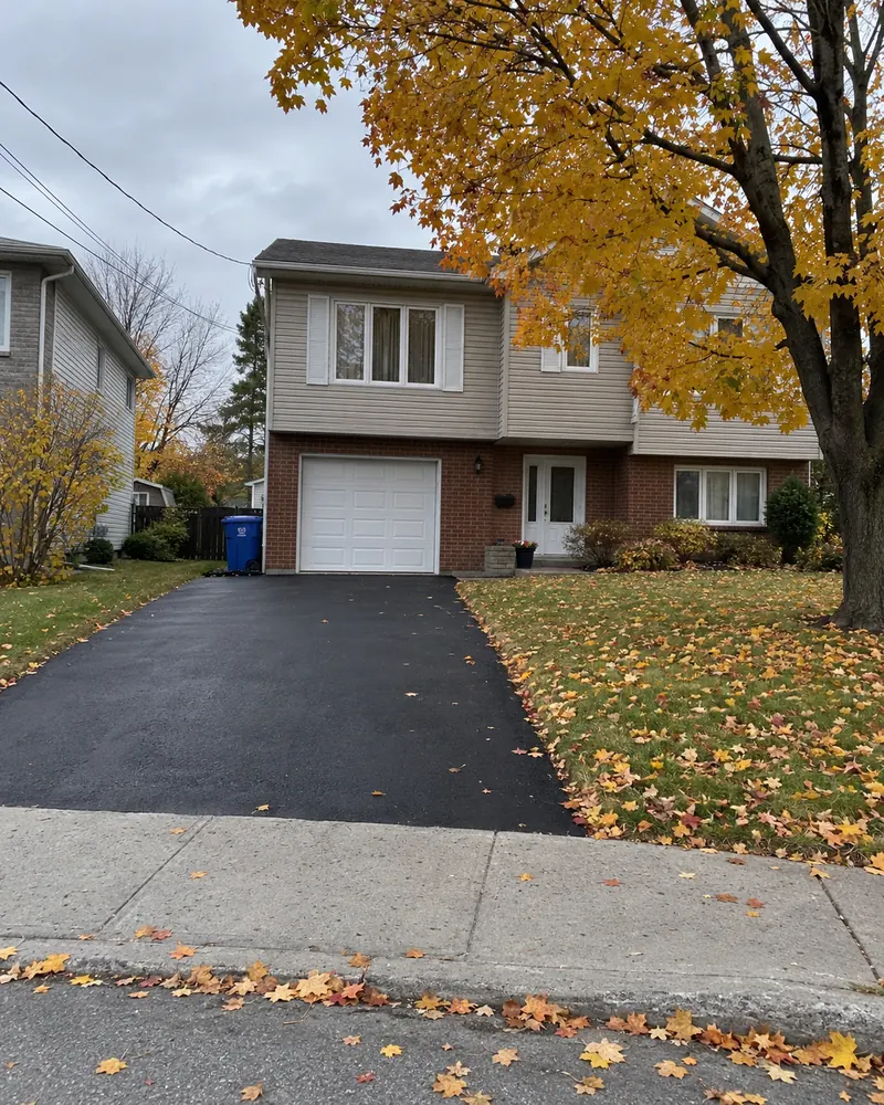 Before and after: an old cracked driveway becomes a new asphalt driveway